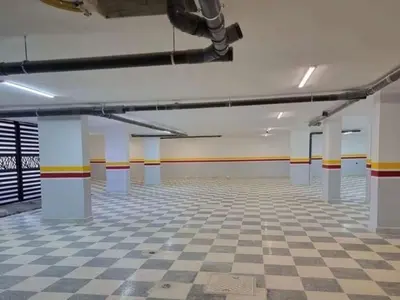a large empty room with a checkered floor at Bargos Cave in Amman