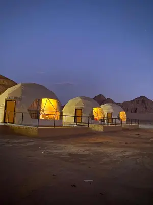 a row of domes in a desert at night at Sela wadi rum in Wadi Rum