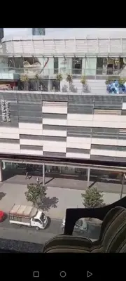 a view of a parking lot with a bus in front of a building at برج داماك الطابق in Amman