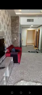 a living room with a red couch in a room at برج داماك الطابق in Amman