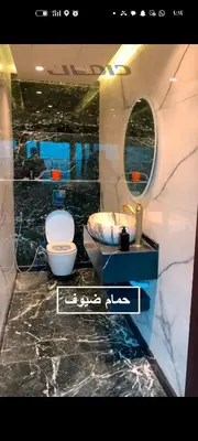 a bathroom with a toilet and a sink and a mirror at شقه دوبلكس داماك العبدلي in Amman
