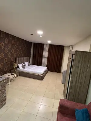 a large room with a bed and a couch at Al-RAYAN HOTEL SUITES in Amman