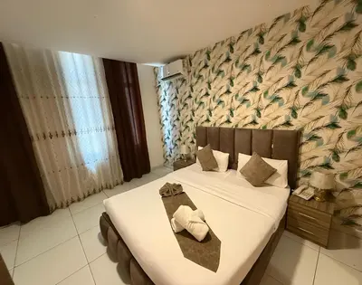 a bedroom with a bed with two towels on it at Al-RAYAN HOTEL SUITES in Amman