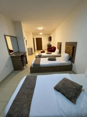 a hotel room with two beds and a bathroom at Al-RAYAN HOTEL SUITES in Amman