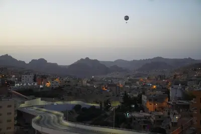 a view of a city with buildings and mountains at Uncle Ali hotel in Wadi Musa