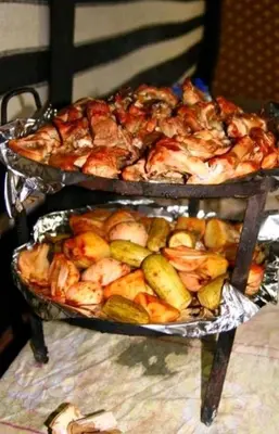 two trays of food with shrimp and vegetables on a table at Wadi rum camp with tour in Wadi Rum