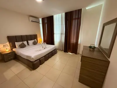 a bedroom with a large bed and a mirror at Ryan Hotel Suites in Amman