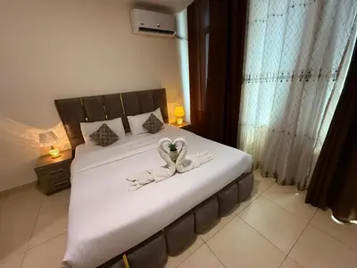 a bedroom with a bed with two towels on it at Ryan Hotel Suites in Amman