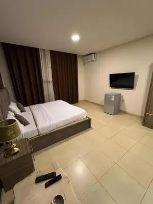 a hotel room with a bed and a tv at Ryan Hotel Suites in Amman