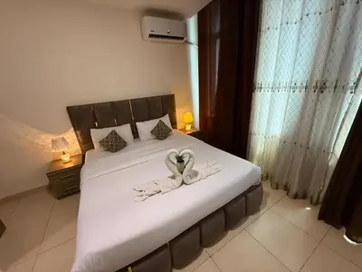 a bedroom with a bed with towels on it at Ryan Hotel Suites in Amman