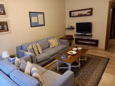 a living room with two couches and a coffee table at Happy Family Home with Spacious Garden in Amman