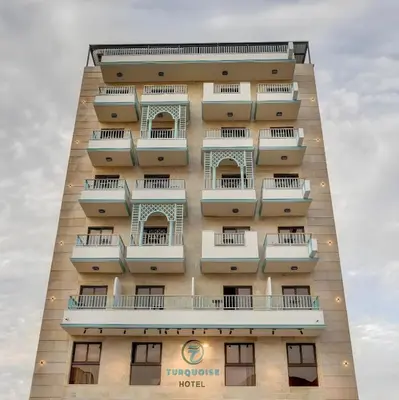 a hotel with balconies on the side of a building at Turquoisejo Hotel in Aqaba