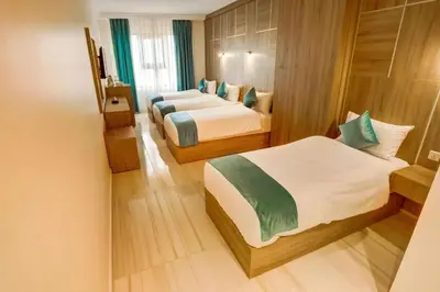 a bedroom with two beds in a room at Turquoisejo Hotel in Aqaba