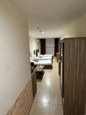 a hospital room with two beds and a couch at El RAYYAN HOTEL SUITES in Amman