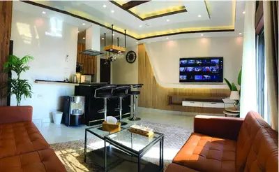 a living room with a couch and a tv at Alsadi Housing- Jabal Amman in Amman