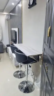 an office with a desk with two chairs and a table at Beit Alhana in Amman