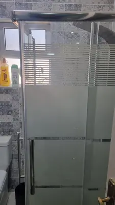 a shower with a glass door in a bathroom at Beit Alhana in Amman