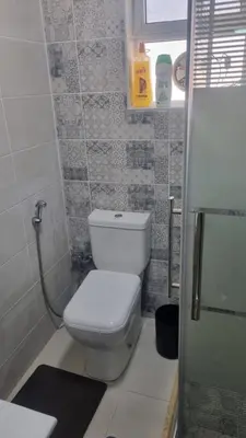 a small bathroom with a toilet and a shower at Beit Alhana in Amman
