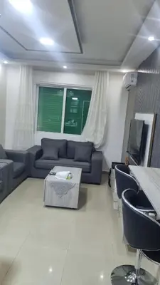a living room with a couch and a tv at Beit Alhana in Amman