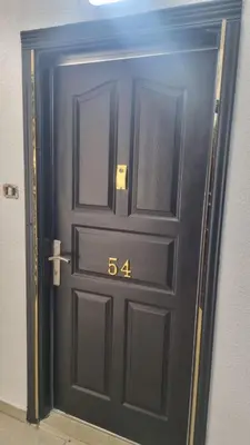 a black door with the number on it at Beit Alhana in Amman