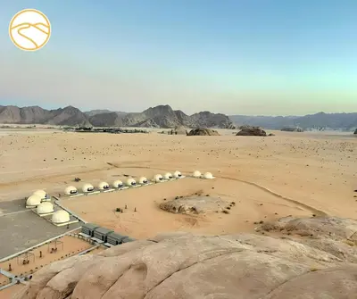 a view of a desert with rocks and mountains at Amber Luxury Camp in Maḩaţţat Dīsah