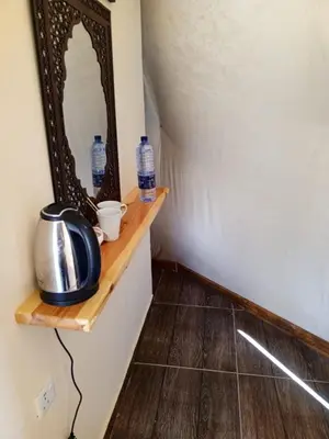 a mirror sitting on a shelf in a room at Amber Luxury Camp in Maḩaţţat Dīsah