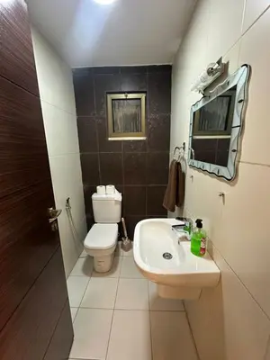 a small bathroom with a toilet and a sink at Royal in Amman