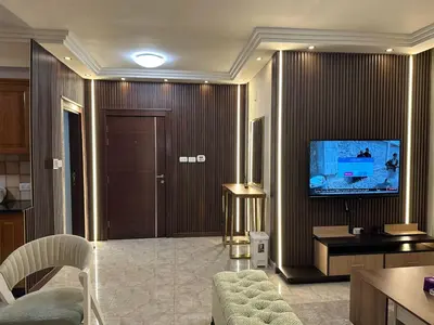 a living room with a television and a couch at Royal in Amman