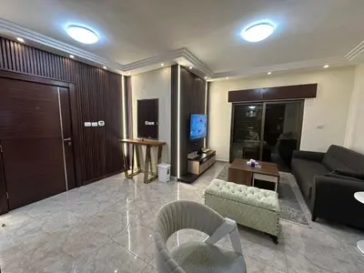 a living room with a couch and a television at Royal in Amman