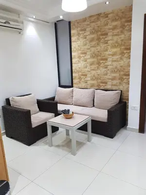 a living room with two couches and a table at Waleed's Studio in Amman
