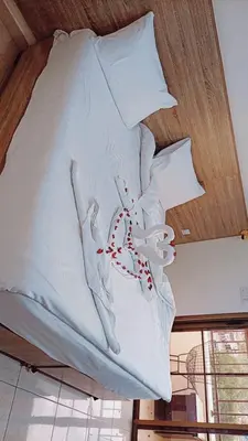 a bed with white sheets and red candy canes on it at فندق الشلالات العقبه Waterfalls Hotel Aqaba in Aqaba