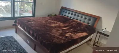 a bedroom with a bed with a brown blanket on it at Luxurious cozy apt 2 in Amman