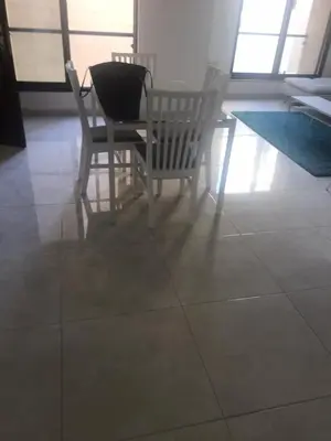 a dining room with two chairs and a table at Luxurious cozy apt 2 in Amman
