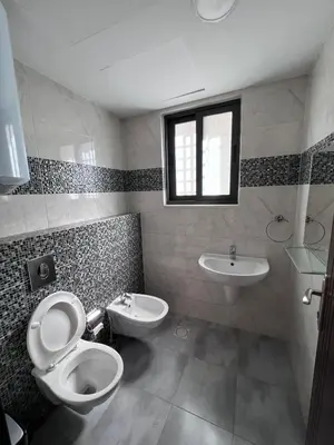 a bathroom with a toilet and a sink at Luxurious cozy apt 2 in Amman