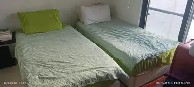 two beds sitting next to each other in a room at Luxurious cozy apt 2 in Amman