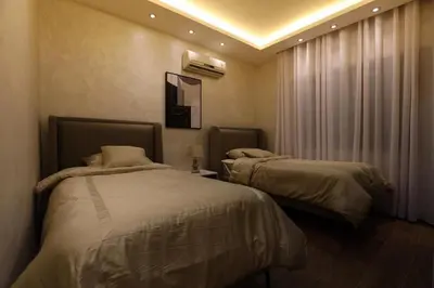 a bedroom with two beds and a window at A luxurious apartment for relaxation in Amman in Amman