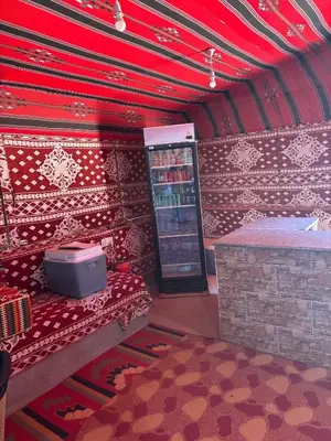 a room with a drink machine and a red ceiling at Panorama Wadi Rum Sunset Camp in Wadi Rum