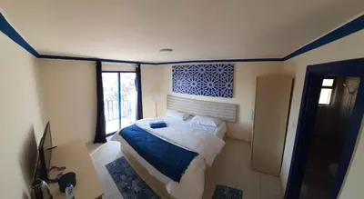 a bedroom with a bed in a room with a window at citadel mountain sun guest house in Amman