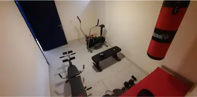 an aerial view of a fitness room with a gym at citadel mountain sun guest house in Amman