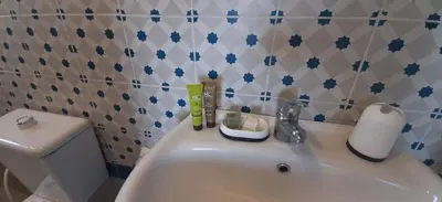 a bathroom with a white sink and a toilet at citadel mountain sun guest house in Amman