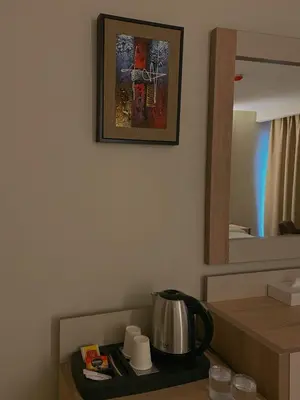 a tea kettle on a tray in a room at Aysel Hotel in Aqaba