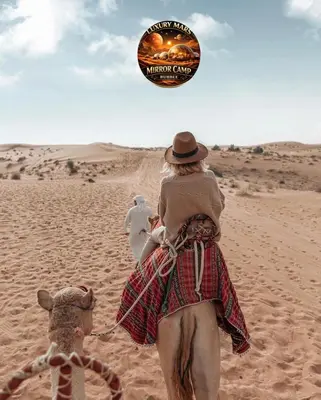 a woman riding a camel in the desert at MARS MIRROR BUBBLE lUXURY CAMP in Wadi Rum