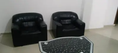 two black leather chairs sitting next to each other at Ara Home in Amman