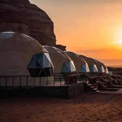 a row of domes on the beach at sunset at Wadi Rum Jeep Tour Sleeping under the stars in Wadi Rum