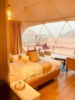 a bedroom on a boat with a bed and a window at Wadi Rum Jeep Tour Sleeping under the stars in Wadi Rum