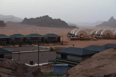 a group of domes in the middle of a desert at Wadi Rum Jeep Tour Sleeping under the stars in Wadi Rum