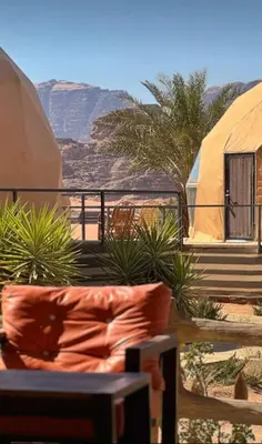 a couch in front of a view of the desert at Wadi Rum Jeep Tour Sleeping under the stars in Wadi Rum