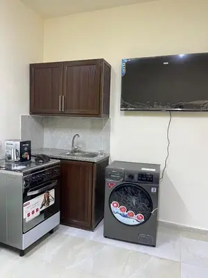 a kitchen with a stove and a washing machine at Osama Alnaser in Amman