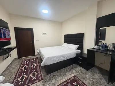 a hotel room with a bed and a television at Qastal Zaman in Amman