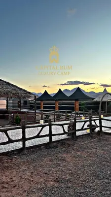 a fence in front of a building with a sign at CAPITAL RUM lUXURY CAMP in Wadi Rum